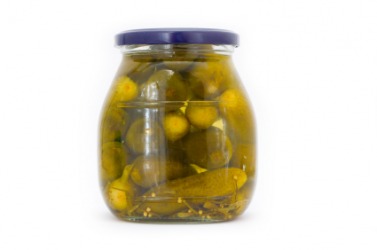 Cucumbers pickling in a jar of brine. Cucumbers pickling in a jar of brine.