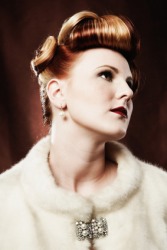 A woman wearing a brooch. A woman wearing a brooch.
