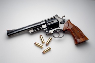 A revolver and the bullets it uses. A revolver and the bullets it uses.