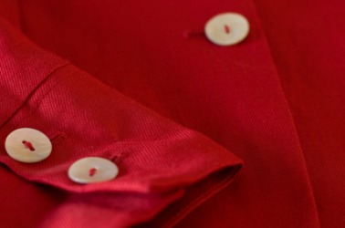 A red shirt with white buttons. A red shirt with white buttons.