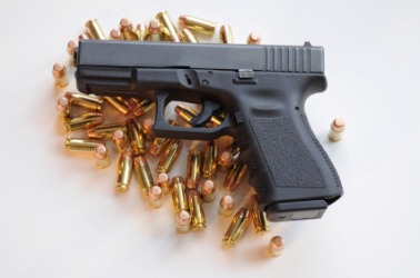 A gun with ammunition. A gun with ammunition.