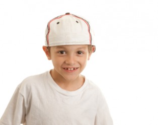 A young boy wearing a baseball cap. A young boy wearing a baseball cap.