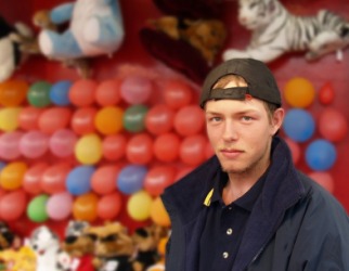 A carny at his carnival booth. A carny at his carnival booth.