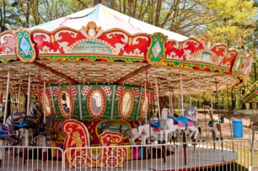 A carousel in a park. A carousel in a park.