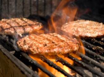 Hamburgers being charbroiled on a grill. Hamburgers being charbroiled on a grill.