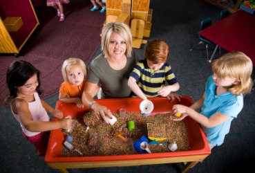 Children and teacher at a child-care center. Children and teacher at a child-care center.