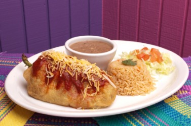 A dish of chile relleno with rice and beans. A dish of chile relleno with rice and beans.