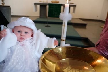 A baby at her christening ceremony. A baby at her christening ceremony.