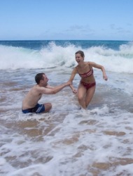 Two people cavorting in the waves. Two people cavorting in the waves.