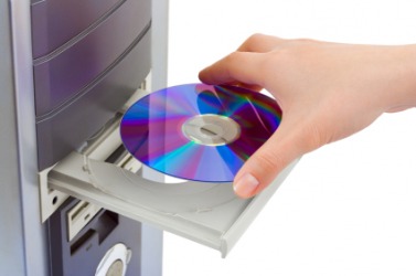 A CD-ROM being placed into a computer. A CD-ROM being placed into a computer.