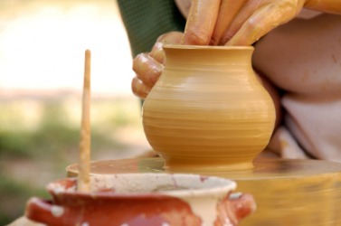 A piece of pottery being formed out of clay. A piece of pottery being formed out of clay.