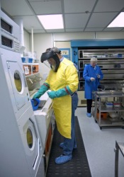Technicians working in a clean room. Technicians working in a clean room.