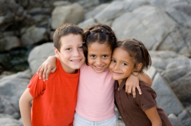 These children are standing very close to each other. These children are standing very close to each other.