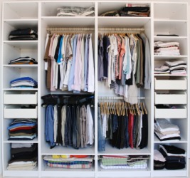 A closet filled with clothing. A closet filled with clothing.