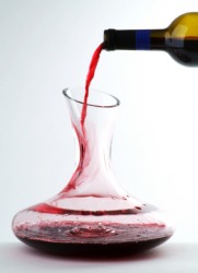 Wine being poured into a decanter. Wine being poured into a decanter.