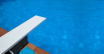 A diving board on a swimming pool. A diving board on a swimming pool.