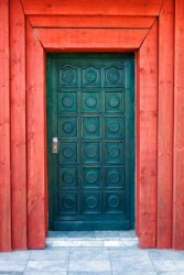 A door with bright red doorjamb or doorpost. A door with bright red doorjamb or doorpost.