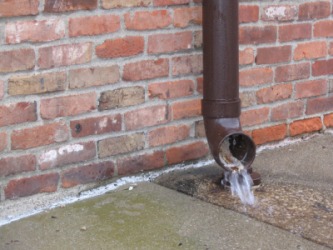 Water running out of a drainpipe. Water running out of a drainpipe.