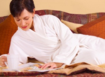 A woman lounges in her dressing gown. A woman lounges in her dressing gown.
