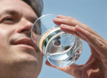 A man about to take a drink of water. A man about to take a drink of water.