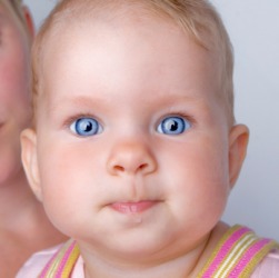 A baby with drool or drivel coming from her lip. A baby with drool or drivel coming from her lip.