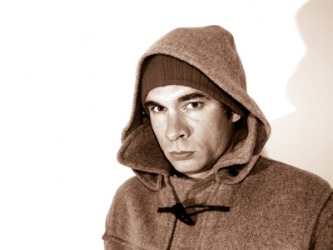 A man wearing a duffel coat. A man wearing a duffel coat.