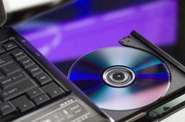 A CD being ejected from a computers CD drive. A CD being ejected from a computers CD drive.
