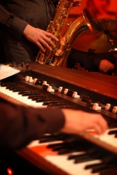 A person playing an electronic organ. A person playing an electronic organ.