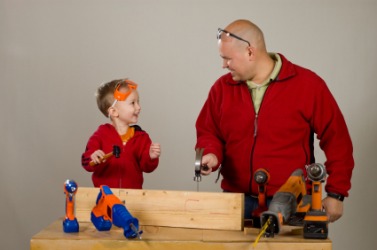 A little boy trying to emulate his father. A little boy trying to emulate his father.