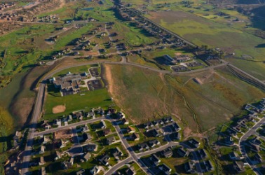 An urban area encroaching upon the rural landscape. An urban area encroaching upon the rural landscape.