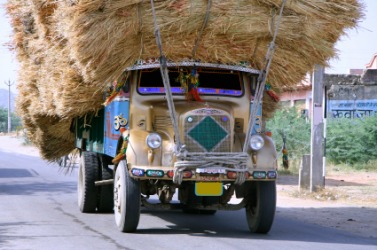 A truck with an encumbrance of hay. A truck with an encumbrance of hay.
