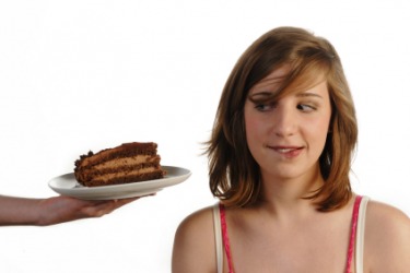 Someone trying to entice this woman with a piece of cake. Someone trying to entice this woman with a piece of cake.