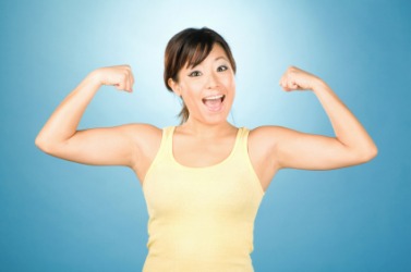 A young woman with her arms flexed. A young woman with her arms flexed.