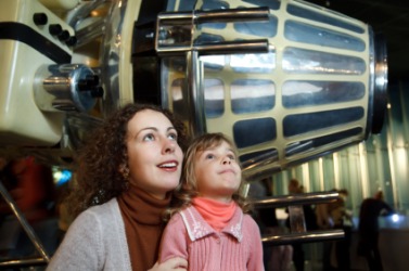 A mother and daughter at an astronautics exhibit. A mother and daughter at an astronautics exhibit.