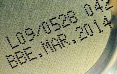 Expiration date on the bottom of a can of food. Expiration date on the bottom of a can of food.