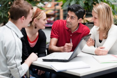 One student gives an explanation to his classmates. One student gives an explanation to his classmates.