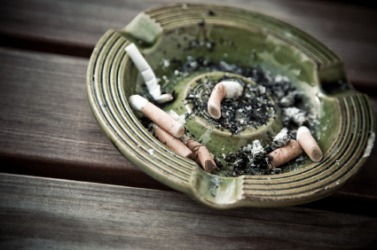 An ashtray containing cigarette butts. An ashtray containing cigarette butts.