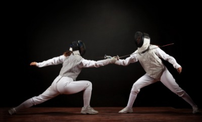 Two fencers in action. Two fencers in action.