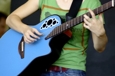 A musician fingerpicking a guitar. A musician fingerpicking a guitar.