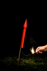 A firework being lit. A firework being lit.