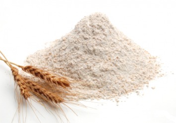 A pile of flour next to ears of wheat. A pile of flour next to ears of wheat.