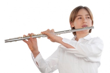 A boy playing a flute. A boy playing a flute.