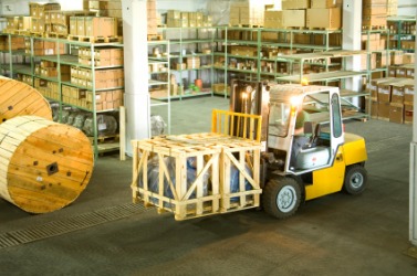 A man operating a forklift. A man operating a forklift.