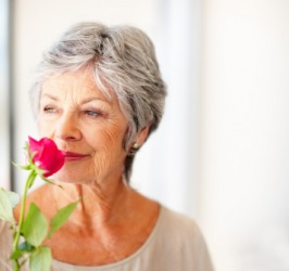 A woman with a fragrant rose. A woman with a fragrant rose.