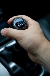 A driver uses a gearshift. A driver uses a gearshift.