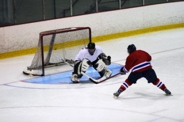 A hockey player guards the goal. A hockey player guards the goal.