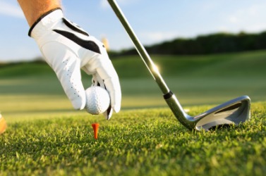 A golf ball is being placed on a tee. A golf ball is being placed on a tee.