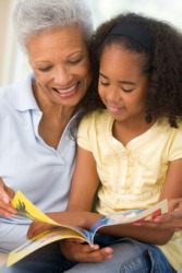 A grandmother reads to her granddaughter. A grandmother reads to her granddaughter.