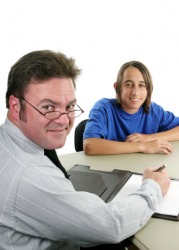 A student talks with his guidance counselor. A student talks with his guidance counselor.
