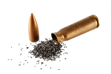 Gunpowder pouring from an open bullet. Gunpowder pouring from an open bullet.